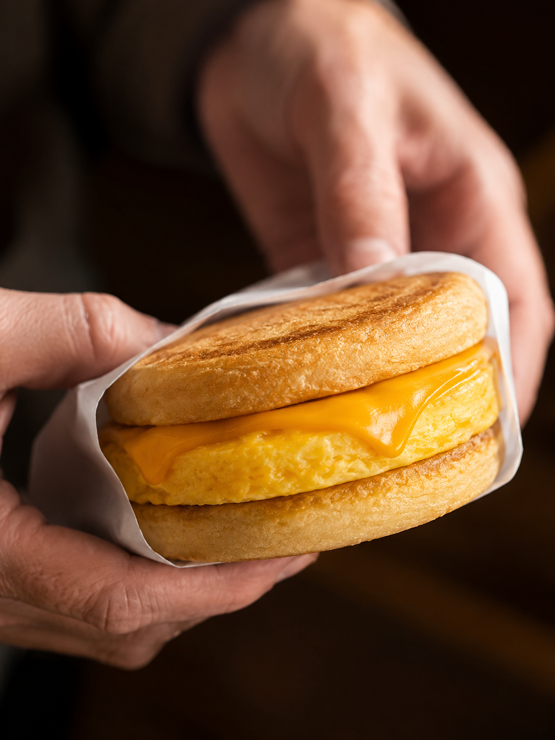 Breakfast sandwich in hands